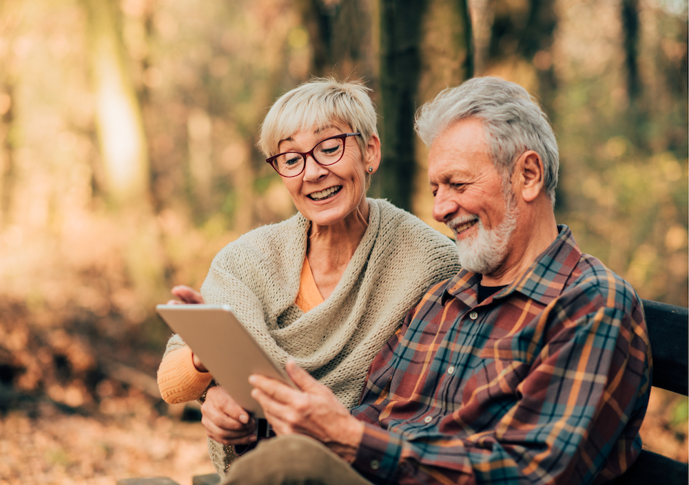 JMR Insurance - image of a happy elderly couple on a park bench